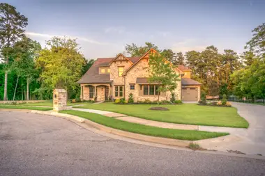 Brick family home with a freshly coated roof and tidy lawn