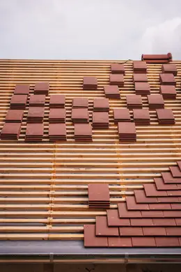 Fresh tiles and battens laid out across a Christchurch roof mid re-roof