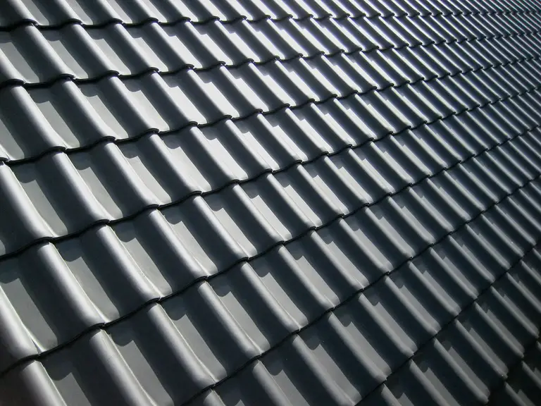Charcoal steel roof catching low evening light