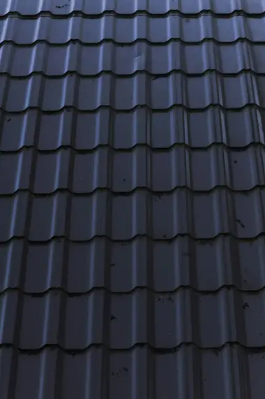 Close-up of new dark long-run steel roofing