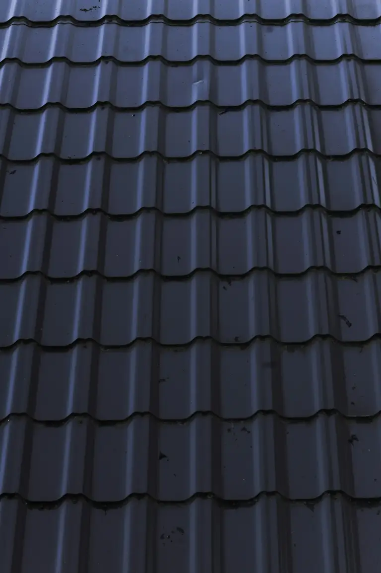 Close-up of new dark long-run steel roofing