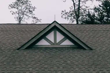 Roof gable with new dark shingle and a feature window