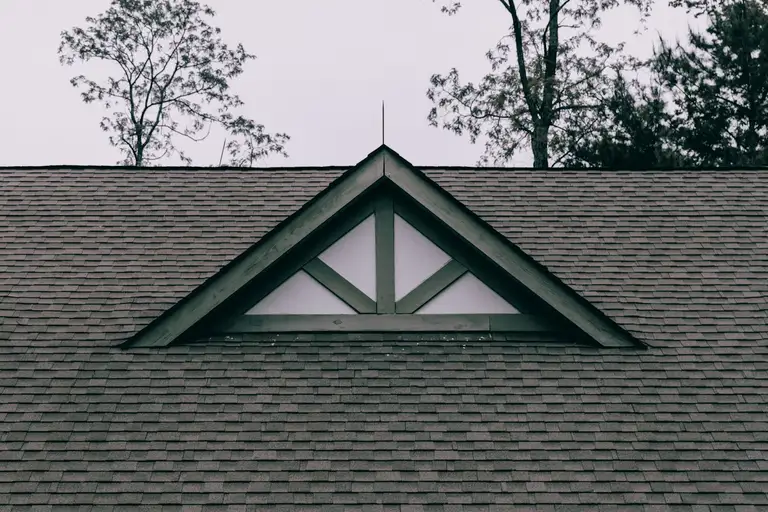 Roof gable with new dark shingle and a feature window