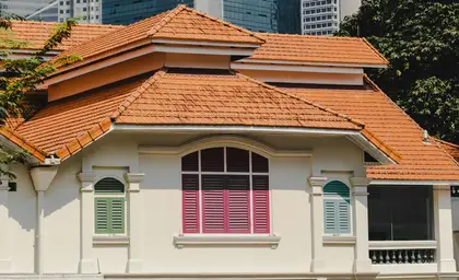Older home with a tired, weathered concrete tile roof before work